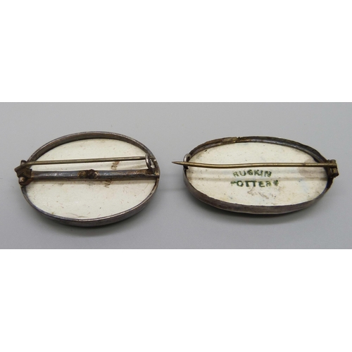 7114 - Two white metal framed Ruskin plaque brooches, 4.4cm and 4cm