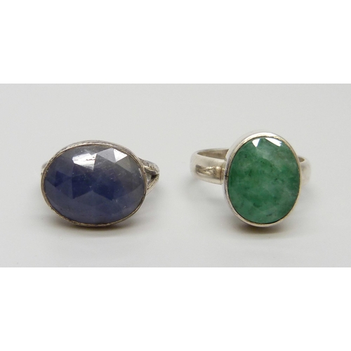 7128 - A silver ring set with an emerald, P, and one set with a sapphire, N, both boxed