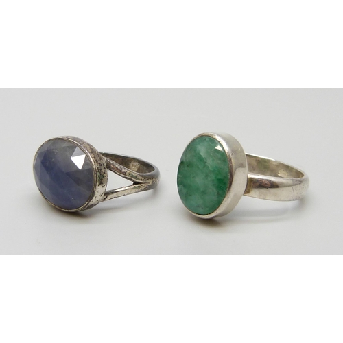 7128 - A silver ring set with an emerald, P, and one set with a sapphire, N, both boxed