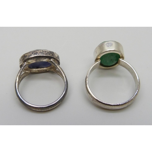 7128 - A silver ring set with an emerald, P, and one set with a sapphire, N, both boxed