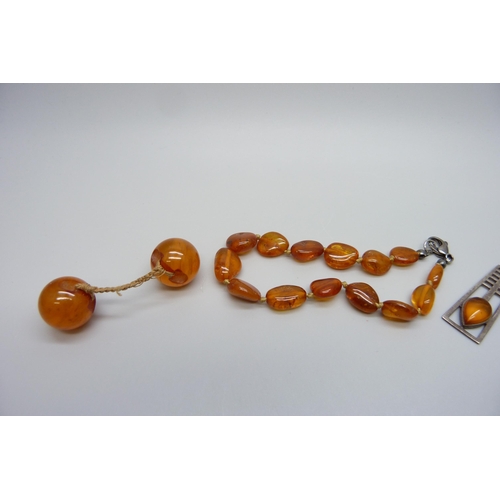 7130 - Three silver and amber pendants on chains, together with other amber