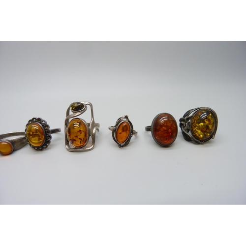 7132 - Seven silver and amber rings, 38g, largest 3cm