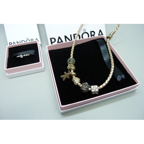 7148 - A Pandora necklace with six charms, and a Pandora ring, K