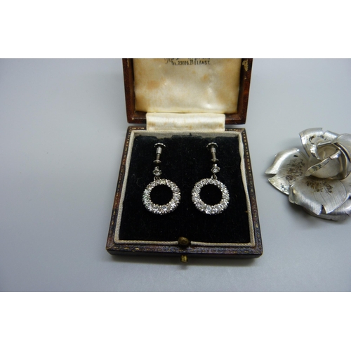 7155 - A pair of silver Art Deco paste set screw back earrings in fitted case, and a silver flower brooch, ... 