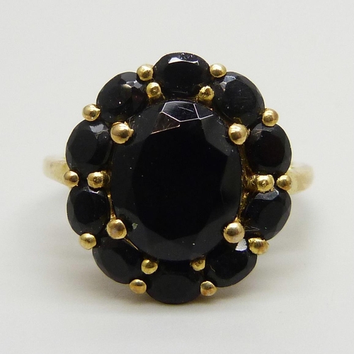 7160 - A silver gilt onyx set cluster ring, R/S, a shell set silver ring, R, and a marcasite set ring, N/O,... 