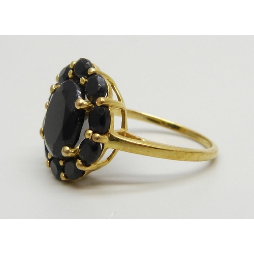 7160 - A silver gilt onyx set cluster ring, R/S, a shell set silver ring, R, and a marcasite set ring, N/O,... 