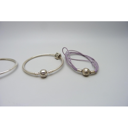 7161 - Three Pandora bracelets, one with an 'R' charm, 27g