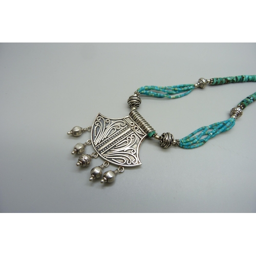 7162 - An Eastern silver and turquoise necklace, 43g