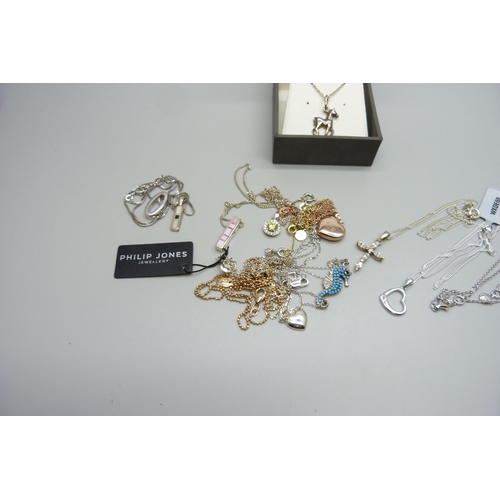 7166 - A collection of silver pendants and chains, 38g