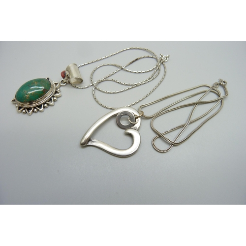 7169 - Two silver pendants and chains including one set with stones, 32g