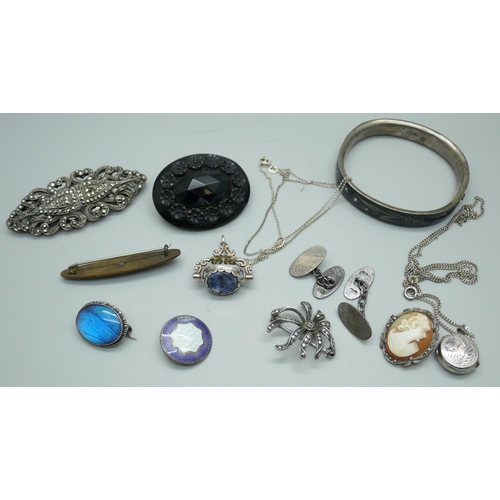 7207 - A jet brooch, a white metal bangle with enamel and seed pearl design, a silver swivel fob, a Victori... 