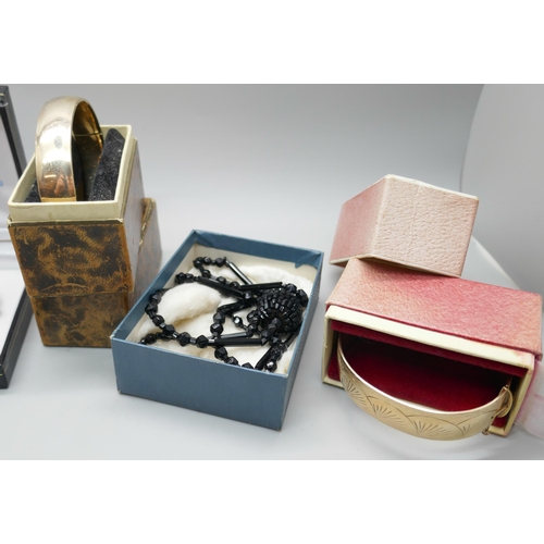 7215 - Two rolled gold bangles, boxed, French jet, a Whitby jet bracelet, a plated collar necklace, glass b... 