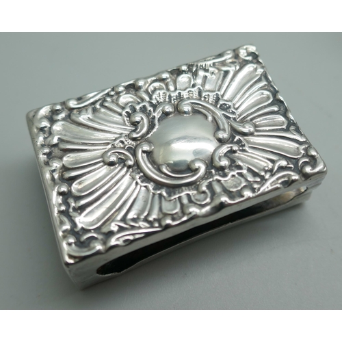 7224 - A silver match box cover, a white metal match box cover, a silver napkin ring, a silver compact (a/f... 