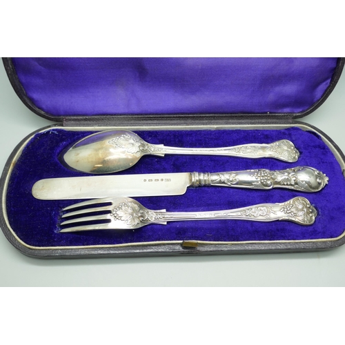 7338 - A Victorian silver vine pattern christening set, spoon and fork by George Adams, London 1867, knife ... 