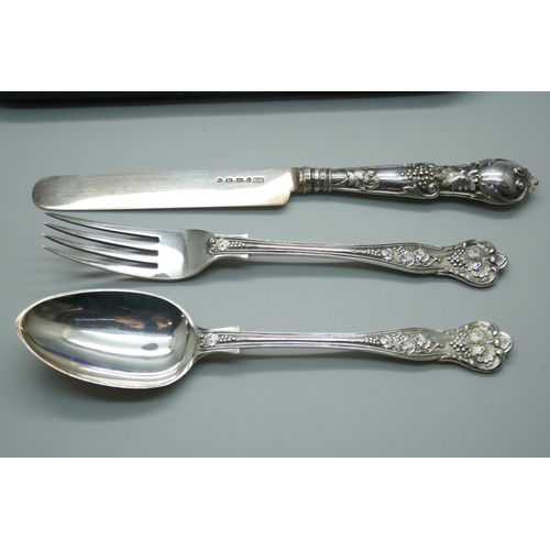 7338 - A Victorian silver vine pattern christening set, spoon and fork by George Adams, London 1867, knife ... 