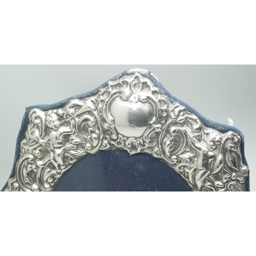 7339 - An embossed silver photograph frame, London 1988, 15cm wide