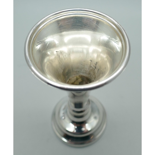 7350 - A silver candlestick, Birmingham 1927 and a silver vase, Sheffield 1980, weighted, vase 8.5cm