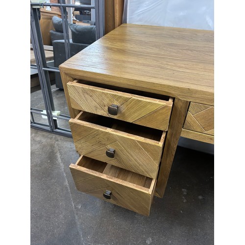 3132 - A brushed and glazed solid oak desk