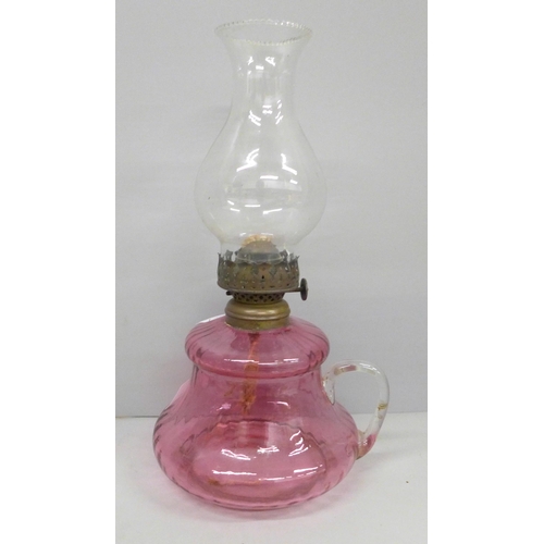 2037 - A cranberry glass oil lamp