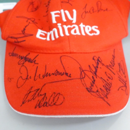 2099 - Golf; a Dubai Desert class official programme, 2002 and three signed caps including Justin Rose, one... 