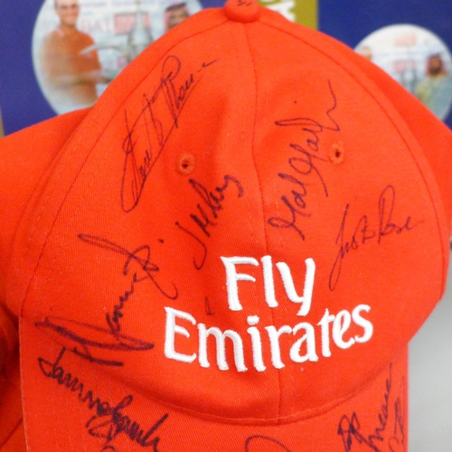 2099 - Golf; a Dubai Desert class official programme, 2002 and three signed caps including Justin Rose, one... 