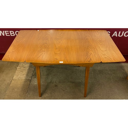 49 - An elm draw-leaf kitchen table and four elm and beech chairs