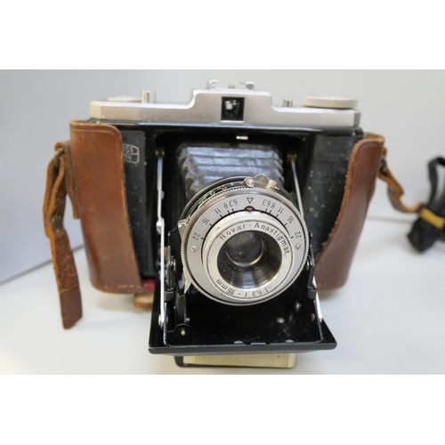 2143 - A selection of photographic equipment including Netar camera and leather case, a Sankyo Super 8-cm v... 