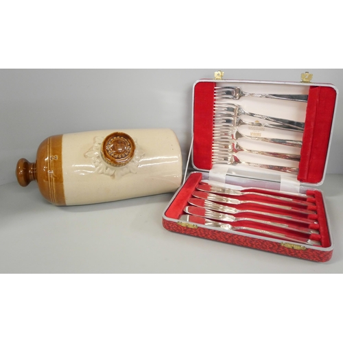 2266 - A set of silver plated fish knives and forks in presentation box and a stoneware water bottle