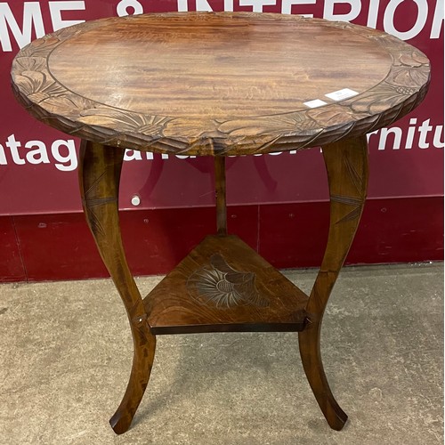 70 - An Arts and Crafts Liberty & Co. style carved beech circular occasional table