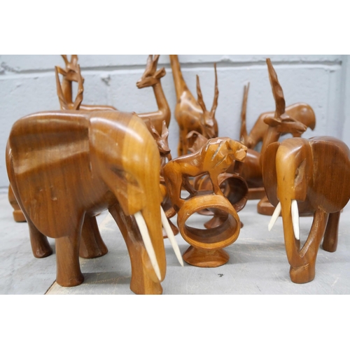 2331 - A collection of African carved wooden serviette rings and other carved animals