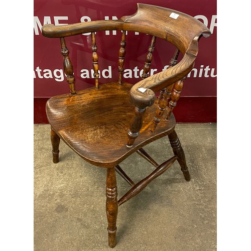 79 - A Victorian elm and beech smokers bow chair, stamped, S. Hirst