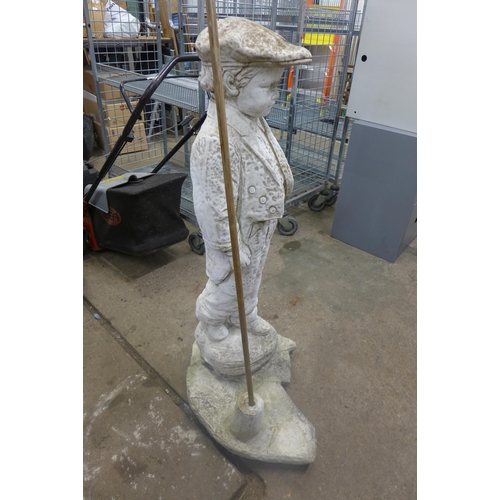 5218 - A concrete garden figure of a Victorian boy with a bamboo cane