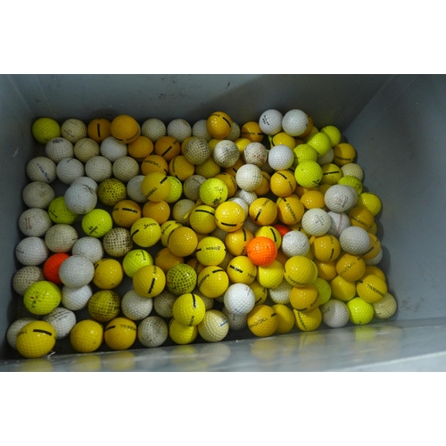 5315 - A plastic storage box containing a quantity of golf balls