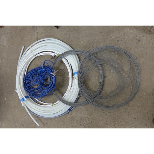 5333 - A coil of water pipe, a coil of electric wire and a coil of fencing wire