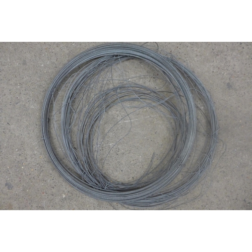 5333 - A coil of water pipe, a coil of electric wire and a coil of fencing wire