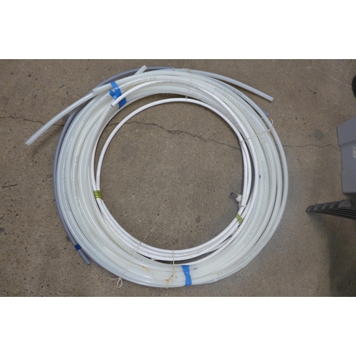 5333 - A coil of water pipe, a coil of electric wire and a coil of fencing wire