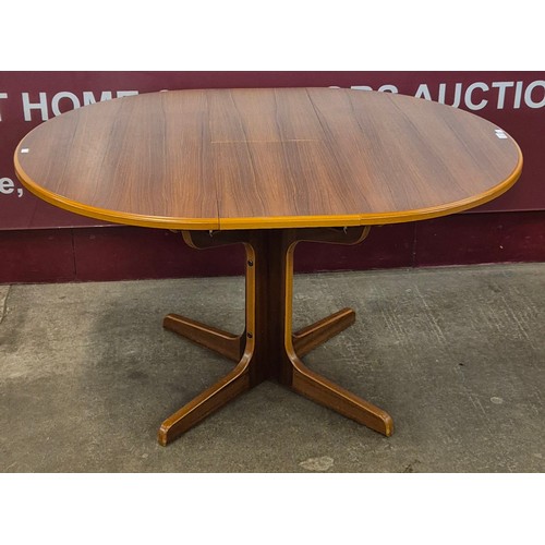 18 - A teak circular extending dining table