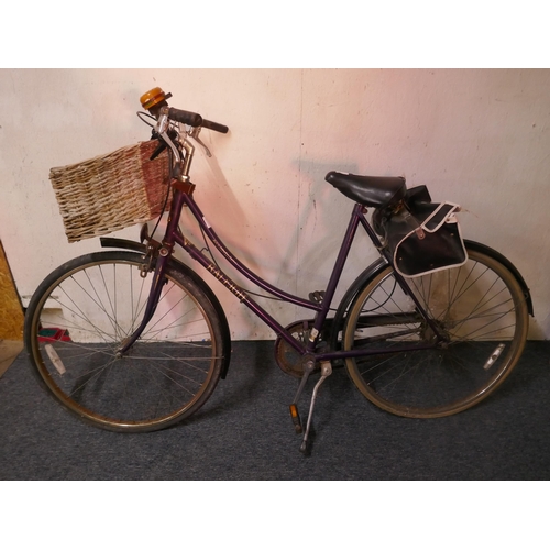 8007 - A vintage Raleigh ladies bike fitted with mud guards, handle bar basket and saddle bag