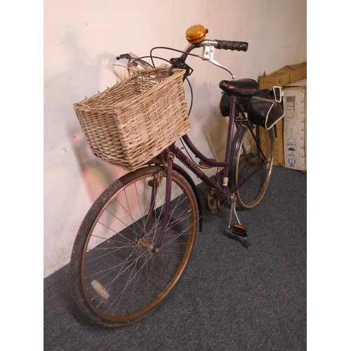 8007 - A vintage Raleigh ladies bike fitted with mud guards, handle bar basket and saddle bag