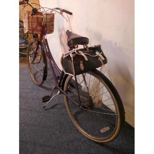 8007 - A vintage Raleigh ladies bike fitted with mud guards, handle bar basket and saddle bag