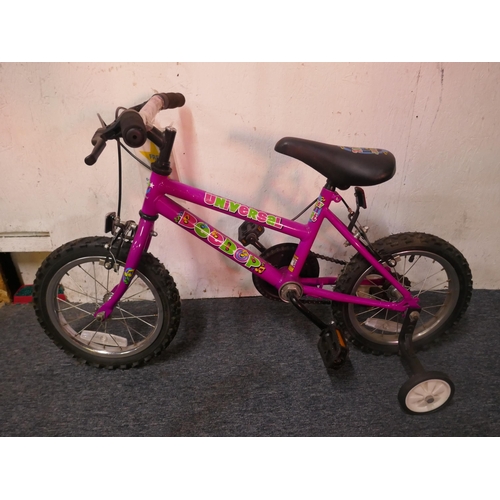 8009 - A Universal Cycles Bee-Bop street beat girls bike with stabilisers and a Universal Cycles children's... 