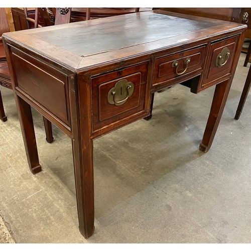 145 - A Chinese elm three drawer writing table