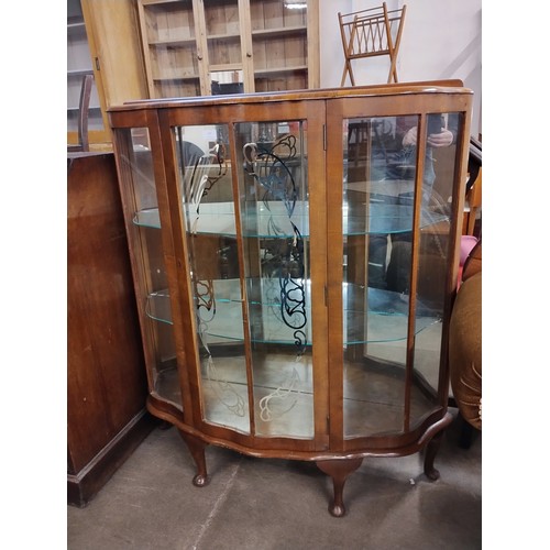 181 - A walnut single door display cabinet