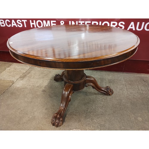 9051 - A George IV walnut circular tilt top breakfast table and two dining chairs