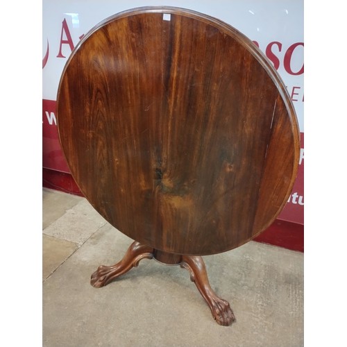 9051 - A George IV walnut circular tilt top breakfast table and two dining chairs