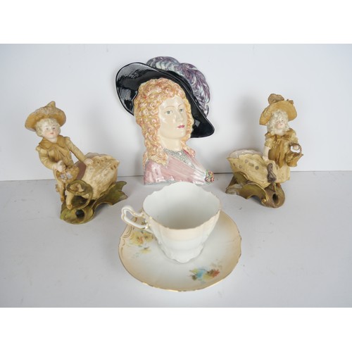 9069 - A Goldscheider wall plaque, two Ernst Wahliss figures and a cup and saucer