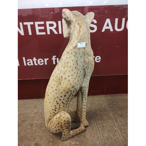 9031 - An African carved figure of a cheetah