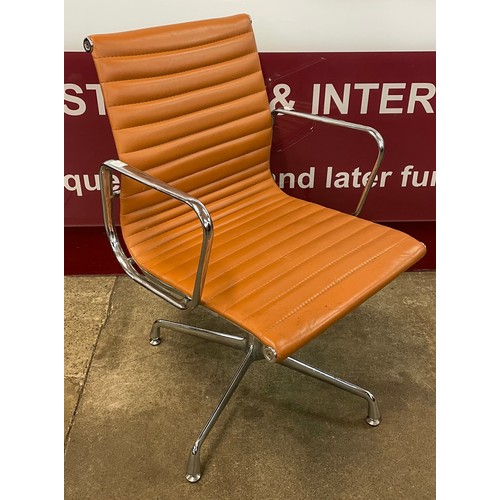 49 - An Eames style chrome and tan leather revolving desk chair