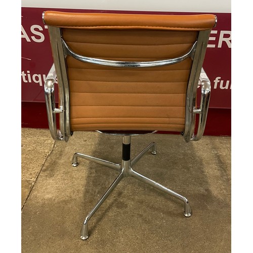 49 - An Eames style chrome and tan leather revolving desk chair