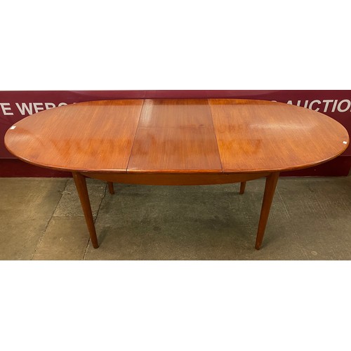 53 - A Jentique teak oval extending dining table and four teak and fabric upholstered dining chairs